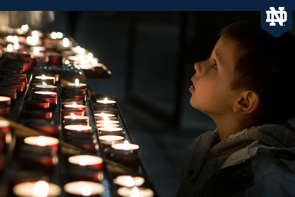 Child looking at candles in wonder
